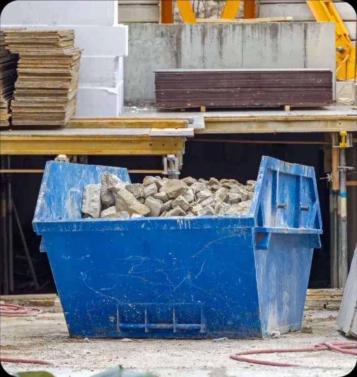 Commercial skip filled with construction debris on a building site